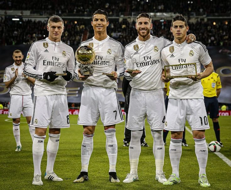 Cristiano Ronaldo, Karim Benzema, and Toni Kroos celebrating Champions League success with Real Madrid.